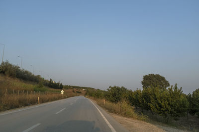 Country road against clear sky