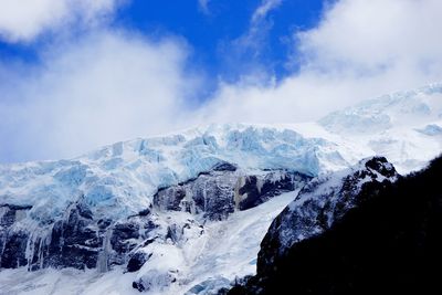 Scenic view of mountains against cloudy sky