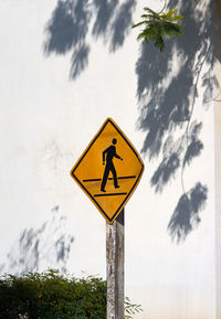 Low angle view of road sign against sky