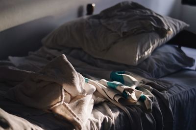 High angle view of messy bed at home