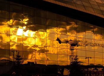 Low angle view of silhouette built structure against sky at sunset