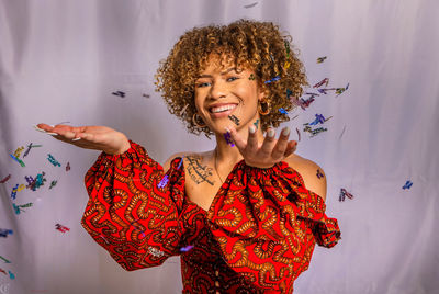 Young woman standing against the wall