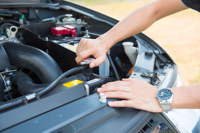 A man checking the auto engine,  uses a wrench to fix the car engine,repair service.