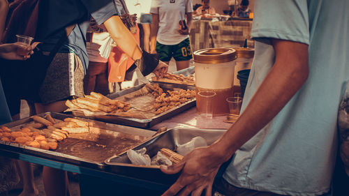 Midsection of man preparing food