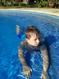 Portrait of young boy swimming in pool