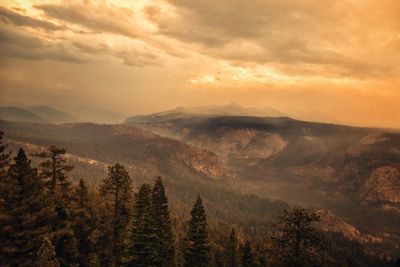 Scenic view of mountains against cloudy sky