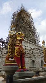 Low angle view of statue against historic building