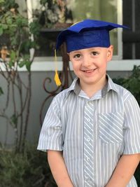 Portrait of smiling boy standing outdoors