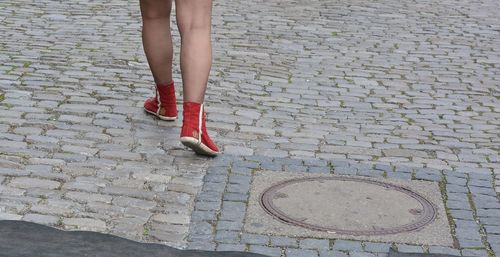 Low section of man standing on footpath