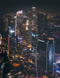 High angle view of illuminated modern buildings in city at night