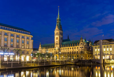 Reflection of illuminated buildings in water at night