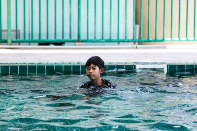 Portrait of man swimming in pool