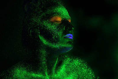 Woman with eyes closed in neon make-up