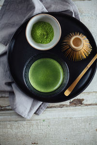 High angle view of cup of matcha tea on table