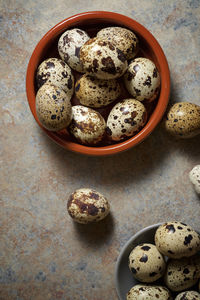 Quail eggs on a stone table.