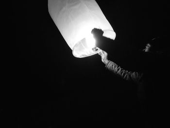 Low angle view of illuminated lights at night