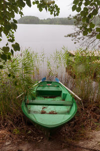 Abandoned boat moored on shore