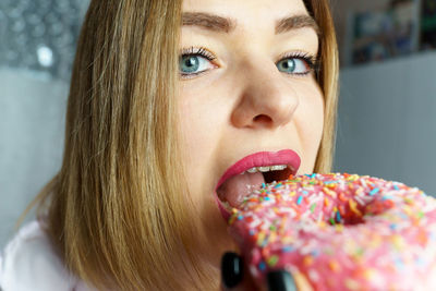 Close-up of young woman eating food