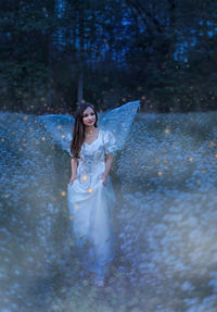 Young woman standing in water