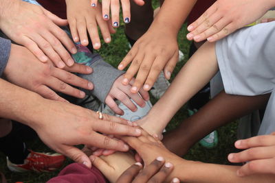 High angle view of friends stacking hands