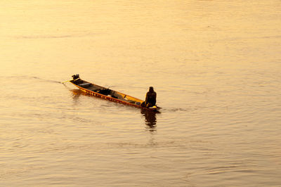 High angle view of people in boat on calm lake