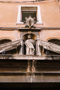 Low angle view of statue against temple