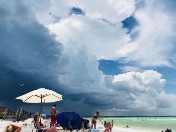 People on beach against sky