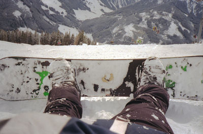 Low section of man on snowcapped mountain