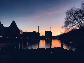 Silhouette buildings against sky during sunset