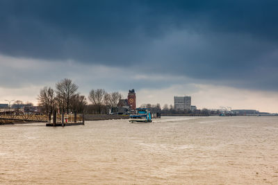 Ferry navigating on the elbe river in a cold cloudy winter day in hamburg