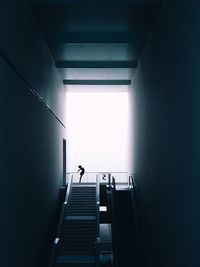 Low angle view of person on staircase in building