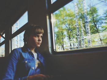 Close-up of young woman sitting in train