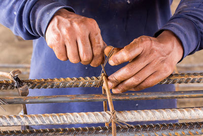 Close-up of man working on metal