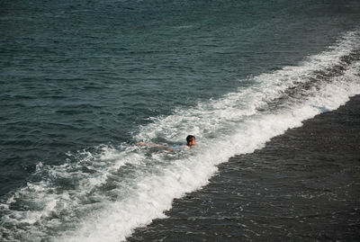 High angle view of man surfing in sea