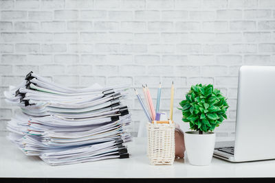Stack of objects on table against wall
