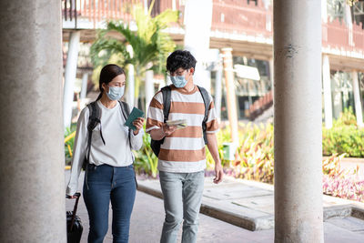 Rear view of couple standing in city