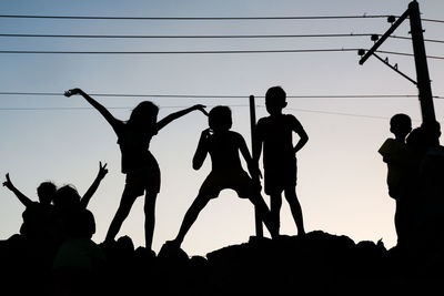 Silhouette people against sky during sunset