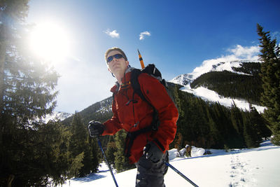 Low angle view of skier standing on snow field