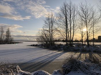 Scenic view of frozen lake against sky during sunset