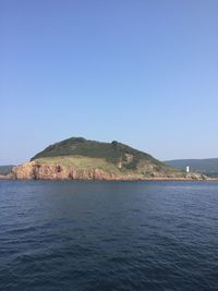 Scenic view of calm sea against clear sky