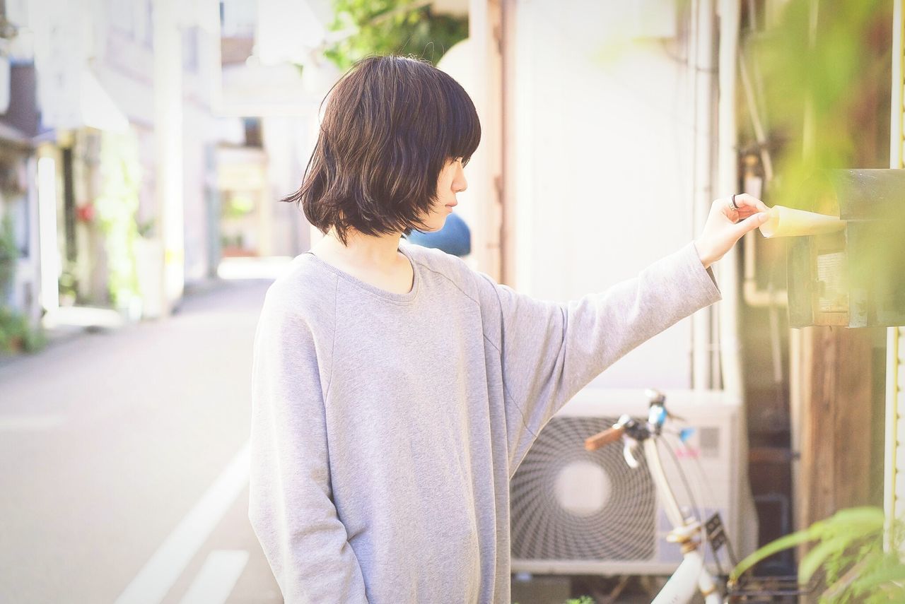 one person, real people, casual clothing, day, focus on foreground, outdoors, standing, young adult, adult, people