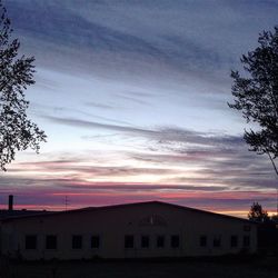 Buildings against sky at sunset