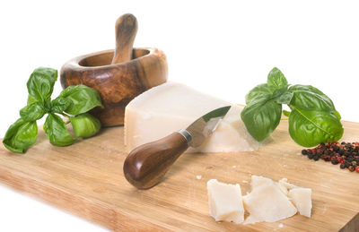 Close-up of fruits and leaves on cutting board