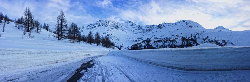 Panoramic view of snowcapped mountains against sky