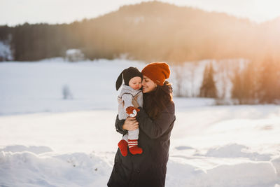 Full length of child on snow covered landscape during winter