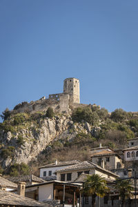 Low angle view of buildings against clear blue sky