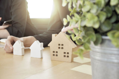 Midsection of man with toy on table in house