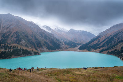 Scenic view of lake and mountains against sky