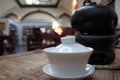 Close-up of white teapot on table