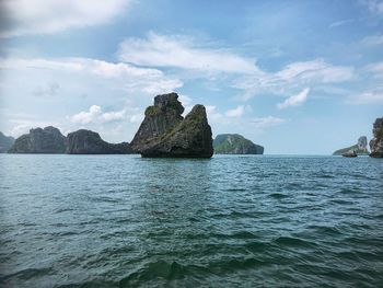 Scenic view of rocks in sea against sky